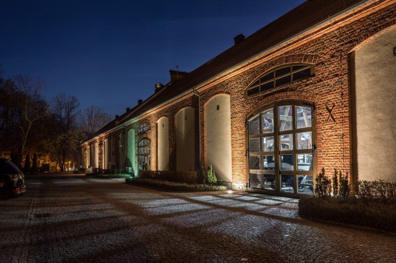 Widok na muzeum motoryzacji z zewnątrz, ceglany budynek.