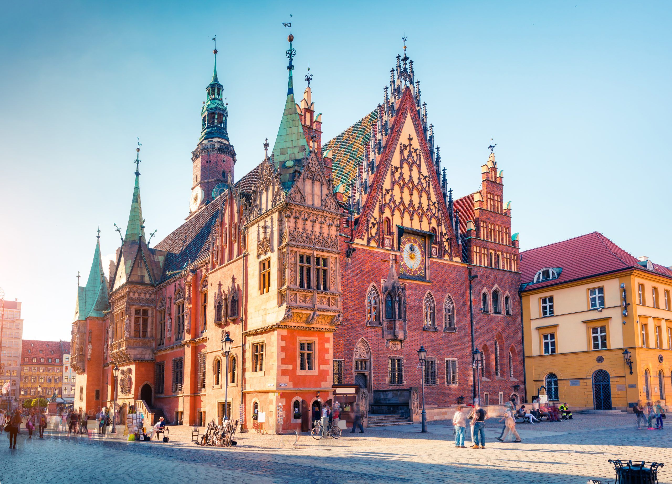 Imponująca gotycka budowla z charakterystyczną, ozdobną fasadą, wysoką wieżą zegarową oraz licznymi rzeźbami i detalami architektonicznymi, które nadają mu wyjątkowy, średniowieczny charakter.